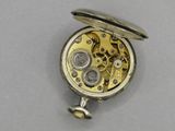 a silver pocket watch with a silver case on it