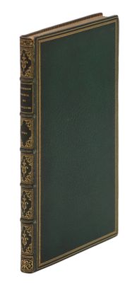 un vieux livre à la couverture verte et aux bordures dorées