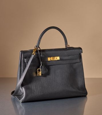 a black leather handbag sitting on top of a table