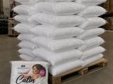 a pile of pillows sitting on a pallet in a warehouse