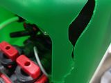 a close up of a green bike with a broken seat