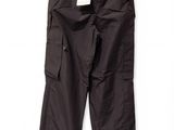 black cargo pants hanging on a hanger on a white wall