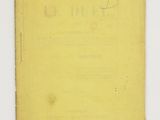 an old book with writing on it sitting on top of a table