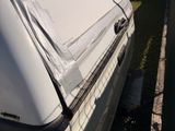 a white car that has been covered with a tarp