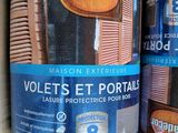 two tins of paint sitting on top of a cardboard box