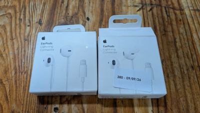 an apple earpods are sitting in a box on a wooden table