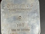 a close up of a metal container on a black surface