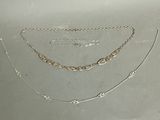 several different types of necklaces and bracelets on a table
