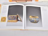 an open book with a picture of a vase and other items