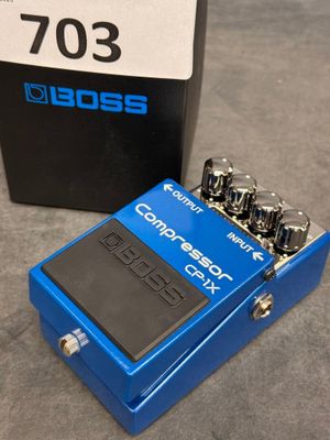 a close up of a pedal sitting on top of a table next to a box