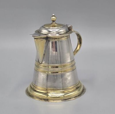 an antique silver coffee pot on a white surface