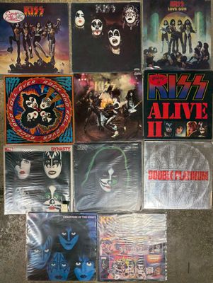 several posters of the band kiss are displayed on a wall