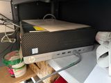 a computer sitting on top of a desk next to a printer