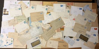 a box full of old letters and envelopes sitting on a table