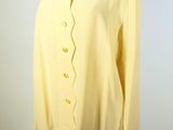 yellow shirt on a mannequin stand with a white background