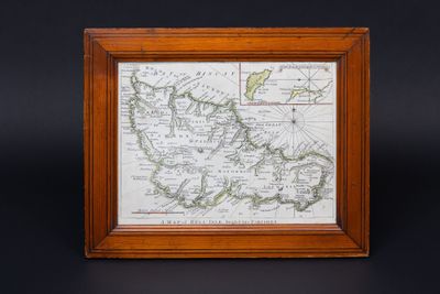 a framed map of the british isles in a wooden frame