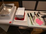 many kitchen utensils on a table with a tray