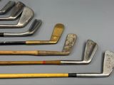 several different types of golf clubs are lined up on a table