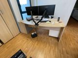 a desk with two monitors and a laptop on it