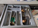 a drawer that has utensils and spoons in it