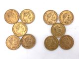 six different types of gold coins on a white surface