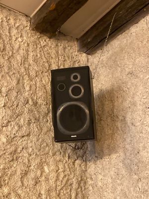 a speaker that is sitting on the floor next to a door