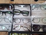 many pairs of glasses in a case on the floor