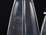 two glass bottles with a wooden top and a small glass bottle with a wooden top