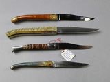 four different types of knives are lined up on a table