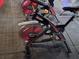 a row of stationary bikes on display in a gym