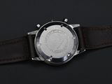 a close up of a watch on a black surface