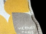a close up of a yellow and grey pillow with a bird on it