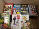 a lot of dvds in a box on the floor