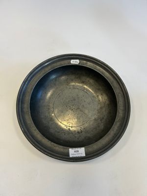 a black metal bowl sitting on top of a white table