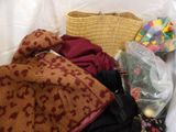a pile of clothes and a basket on the floor