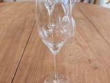 two empty wine glasses sitting on a wooden table