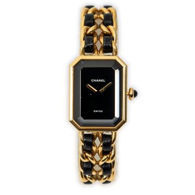 a close up of a gold and black watch on a white background
