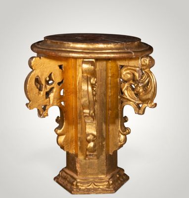 a gold pedestal with a marble top on a white background