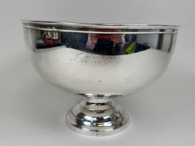 a silver bowl that is sitting on a table