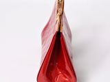 the small red purse is open and ready to be used