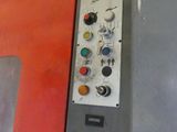 a machine that is sitting in a room with a red wall