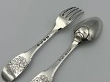pair of silver plated spoons and a fork on a white surface