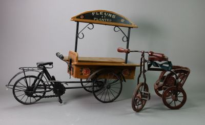 a small cart with a bicycle attached to it