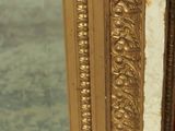 a mirror that is sitting on the floor in front of a chair