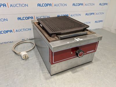 a close up of an electric grill on a counter top