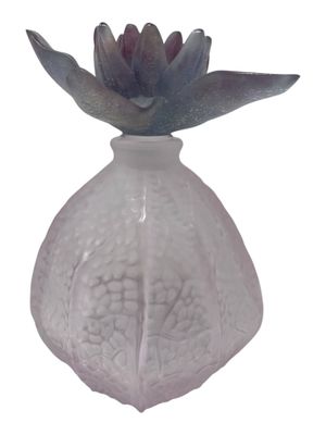 a glass vase with a flower in it on a white background