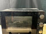 a black toaster oven sitting on a wooden table