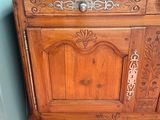 a wooden cabinet with a drawer on top of it