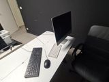 a desk with a computer and a keyboard on it