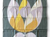 an image of a green and yellow flag with a flower on it